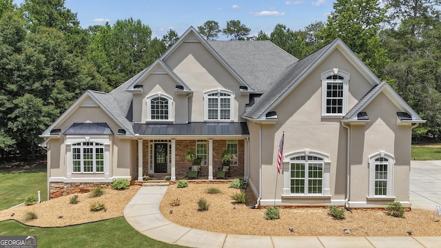 140 Olivia Ct, Fayetteville, GA 30215 - view of front of home with stucco siding, a porch, a standing seam roof, roof with shingles, and a metal roof