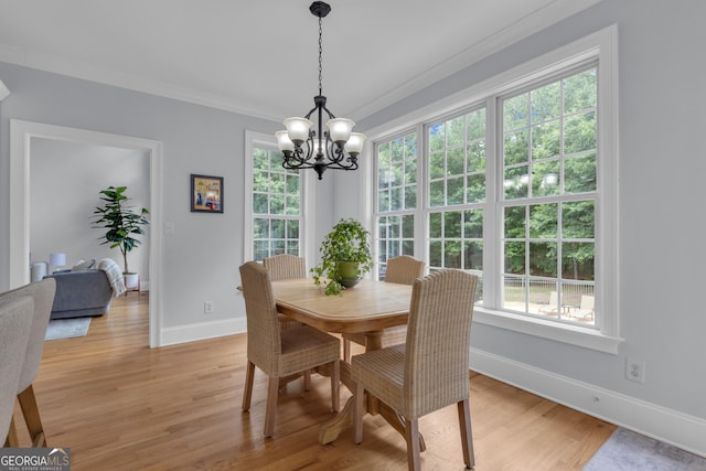 140 Olivia Ct, Fayetteville, GA 30215 - dining area featuring a chandelier, crown molding, and light wood-style flooring