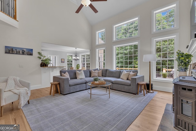 140 Olivia Ct, Fayetteville, GA 30215 - living room featuring high vaulted ceiling, a ceiling fan, a chandelier, and light wood-style floors