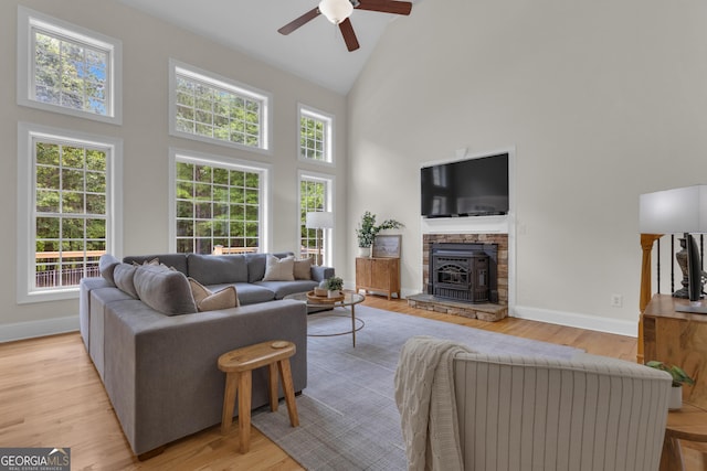 140 Olivia Ct, Fayetteville, GA 30215 - living room with high vaulted ceiling, ceiling fan, light wood-style floors, and a stone fireplace