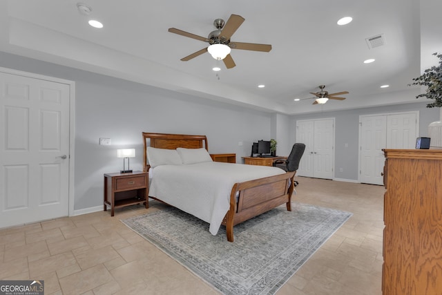 140 Olivia Ct, Fayetteville, GA 30215 - bedroom featuring a tray ceiling, recessed lighting, multiple closets, light stone finish flooring, and a desk