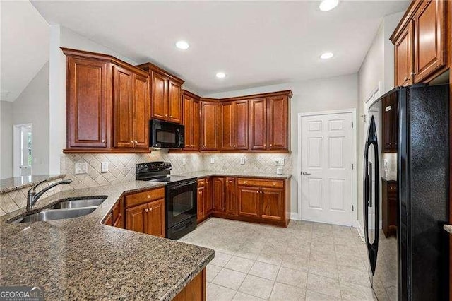2721 Grapevine Cir Unit 1701, Cumming, GA 30041 - kitchen featuring black appliances, decorative backsplash, dark stone countertops, a peninsula, and light tile patterned floors
