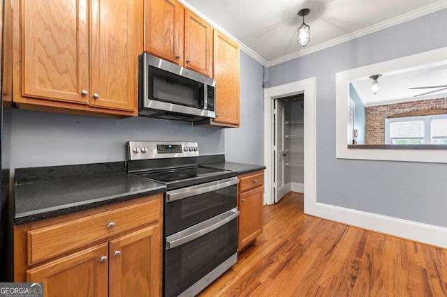 960 Taft Ave NE Unit 9, Atlanta, GA 30309 - kitchen featuring appliances with stainless steel finishes, ornamental molding, light wood-style floors, and brown cabinetry
