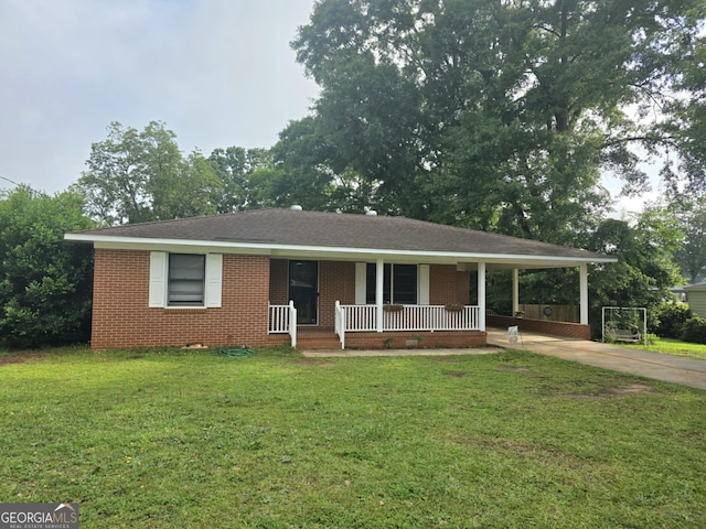 104 Denham St, Thomaston, GA 30286 - view of front of property featuring covered porch, brick siding, a front yard, and concrete driveway