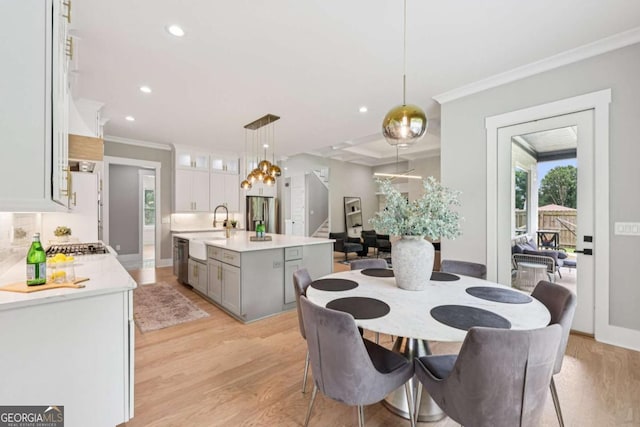 2243 Cain Cir, Dacula, GA 30019 - dining space featuring light wood-style flooring, ornamental molding, recessed lighting, and stairway