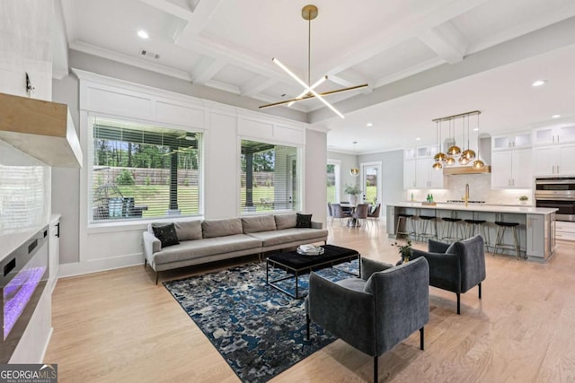 2243 Cain Cir, Dacula, GA 30019 - living area with light wood finished floors, recessed lighting, coffered ceiling, plenty of natural light, and beam ceiling