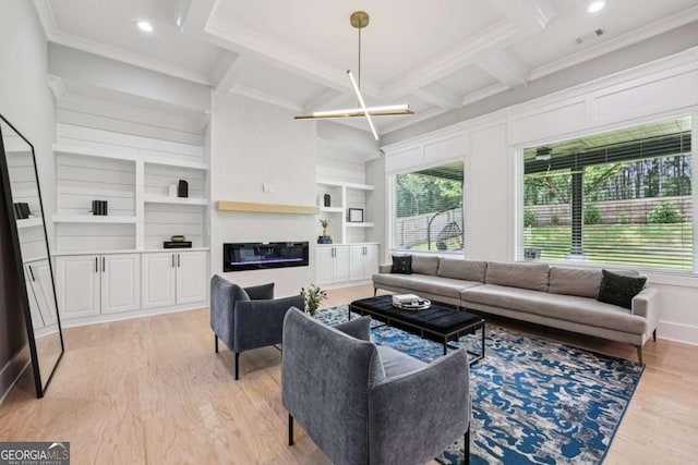2243 Cain Cir, Dacula, GA 30019 - living area with light wood-type flooring, beamed ceiling, ornamental molding, a glass covered fireplace, and built in shelves