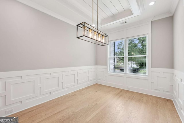 2243 Cain Cir, Dacula, GA 30019 - unfurnished dining area with light wood finished floors, wainscoting, a decorative wall, a chandelier, and recessed lighting