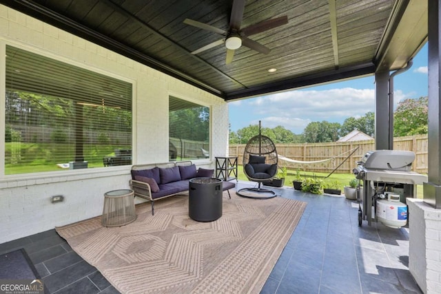 2243 Cain Cir, Dacula, GA 30019 - fenced backyard featuring a grill, a ceiling fan, an outdoor living space, and a patio