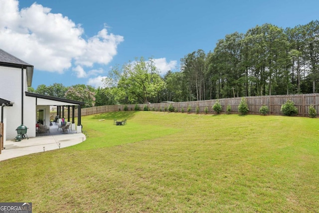 2243 Cain Cir, Dacula, GA 30019 - fenced backyard with a patio and view of wooded area