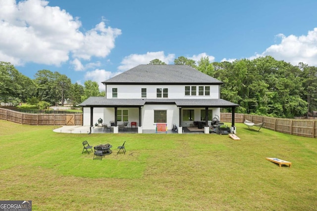 2243 Cain Cir, Dacula, GA 30019 - rear view of house with a patio, a fenced backyard, an outdoor living space with a fire pit, and a shingled roof