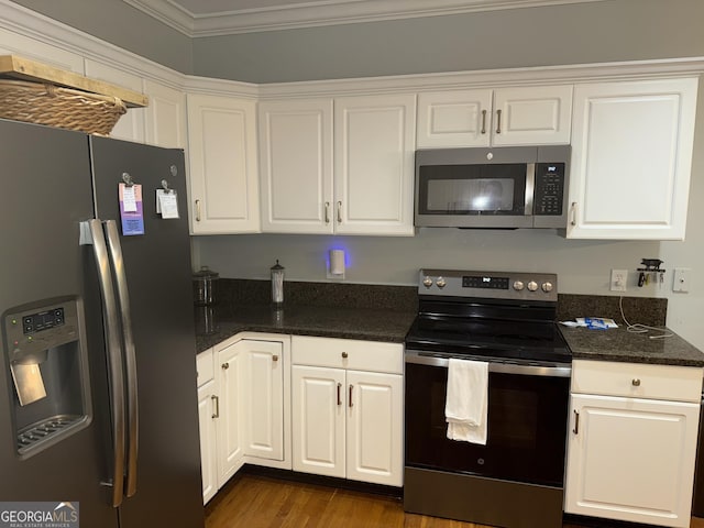 102 Cameron Pointe Dr, Lagrange, GA 30240 - kitchen with stainless steel appliances, white cabinets, dark wood-style flooring, ornamental molding, and dark stone countertops
