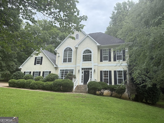 102 Cameron Pointe Dr, Lagrange, GA 30240 - view of front of house with a front yard, a shingled roof, and stucco siding