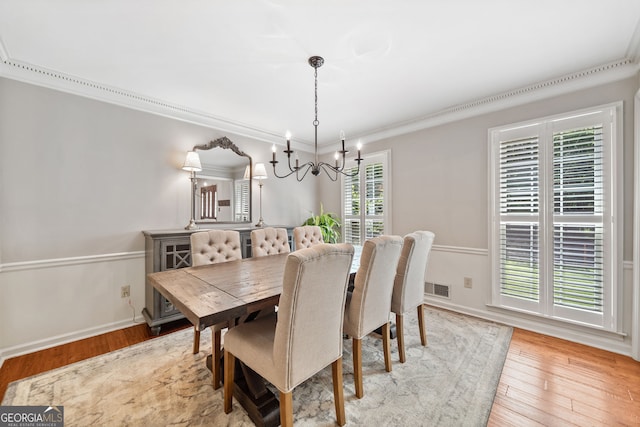 2502 Tritt Springs Trce NE, Marietta, GA 30062 - dining space with a chandelier, light wood-style flooring, and crown molding