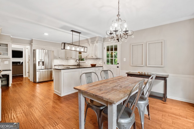 2502 Tritt Springs Trce NE, Marietta, GA 30062 - dining area featuring ornamental molding, a chandelier, light wood-style floors, and recessed lighting