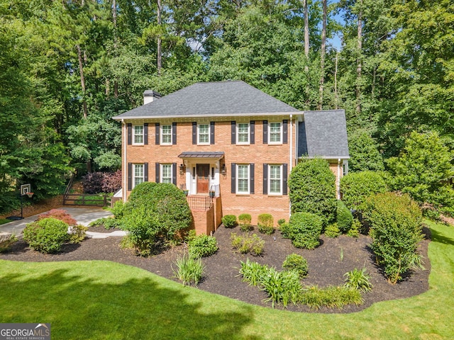 2502 Tritt Springs Trce NE, Marietta, GA 30062 - view of front of house featuring a chimney, brick siding, and roof with shingles