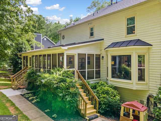 2502 Tritt Springs Trce NE, Marietta, GA 30062 - back of house featuring stairway, a sunroom, and roof with shingles