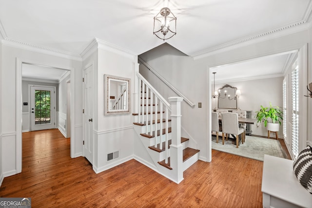 2502 Tritt Springs Trce NE, Marietta, GA 30062 - stairway featuring a chandelier, crown molding, and hardwood / wood-style flooring