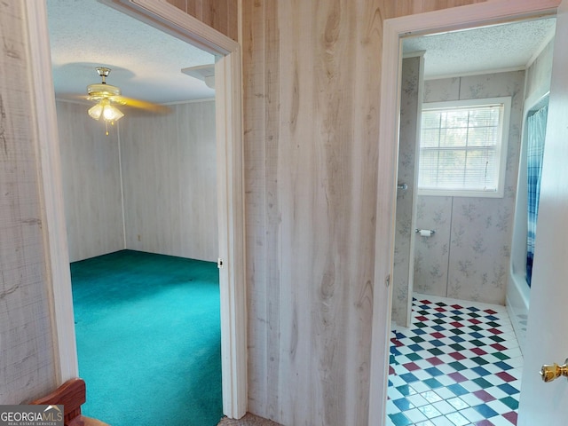 895 Ga Highway 57, Kite, GA 31049 - bathroom featuring a textured ceiling, crown molding, a ceiling fan, wallpapered walls, and a tub to relax in