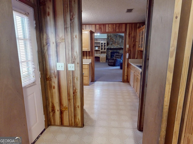 895 Ga Highway 57, Kite, GA 31049 - hallway with light flooring, wooden walls, and a textured ceiling