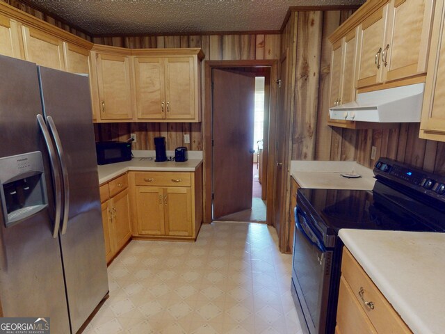 895 Ga Highway 57, Kite, GA 31049 - kitchen featuring black appliances, light floors, under cabinet range hood, wooden walls, and light countertops