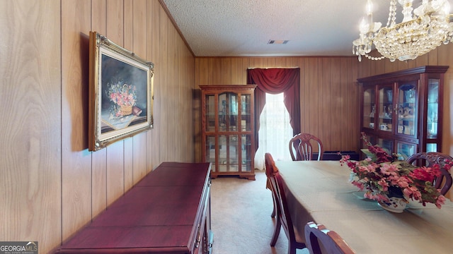 895 Ga Highway 57, Kite, GA 31049 - carpeted dining space with a chandelier, a textured ceiling, and wooden walls
