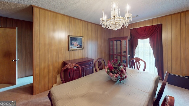 895 Ga Highway 57, Kite, GA 31049 - dining area featuring carpet, a chandelier, a textured ceiling, and wood walls