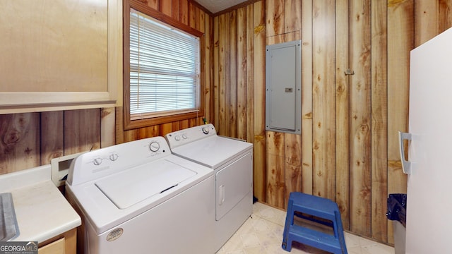895 Ga Highway 57, Kite, GA 31049 - laundry area featuring electric panel, wood walls, and washing machine and clothes dryer