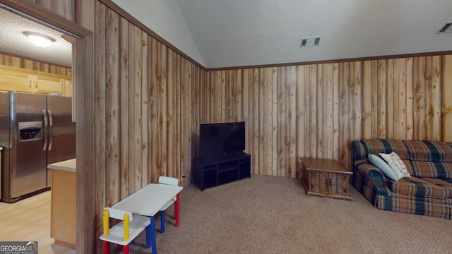 895 Ga Highway 57, Kite, GA 31049 - living area with wood walls, light carpet, and vaulted ceiling