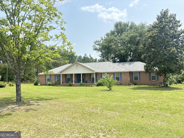 895 Ga Highway 57, Kite, GA 31049 - ranch-style house with a front yard, a porch, and brick siding