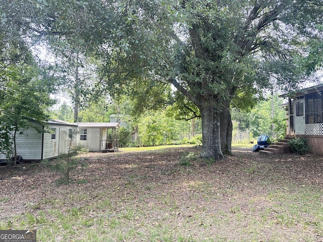895 Ga Highway 57, Kite, GA 31049 - view of yard featuring a sunroom