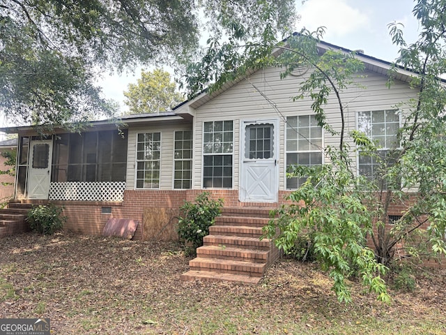 895 Ga Highway 57, Kite, GA 31049 - view of front of house featuring entry steps, brick siding, and a sunroom