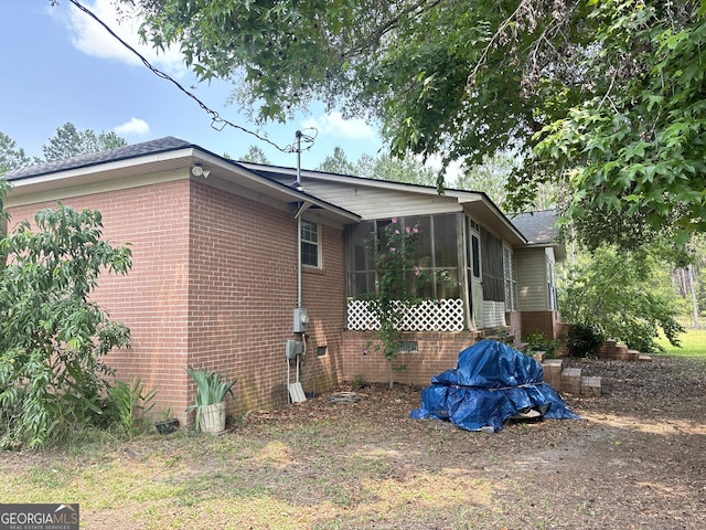 895 Ga Highway 57, Kite, GA 31049 - view of side of home featuring brick siding and a sunroom