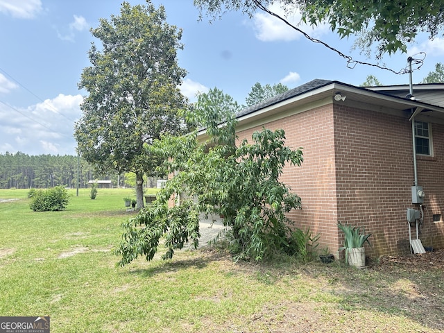 895 Ga Highway 57, Kite, GA 31049 - view of side of property with a lawn and brick siding