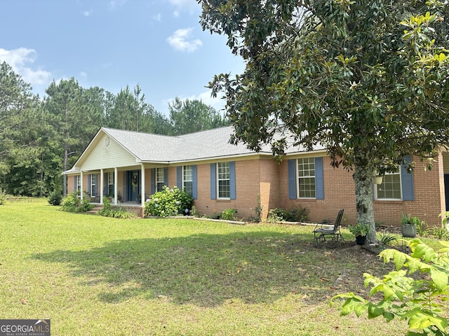 895 Ga Highway 57, Kite, GA 31049 - ranch-style home with covered porch, brick siding, and a front yard