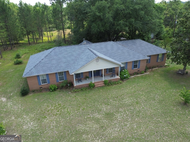 895 Ga Highway 57, Kite, GA 31049 - view of front of property with a porch, a front lawn, roof with shingles, and brick siding
