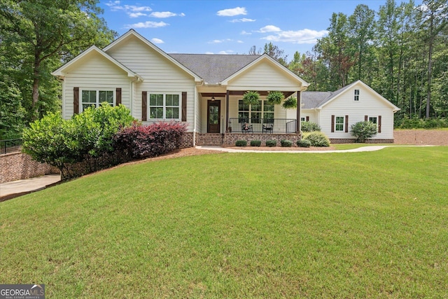 177 Garnett Point Dr, Carrollton, GA 30117 - view of front of home with a porch, a front lawn, and roof with shingles