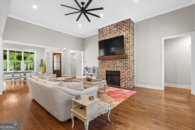 177 Garnett Point Dr, Carrollton, GA 30117 - living area with ceiling fan, wood finished floors, crown molding, a brick fireplace, and recessed lighting