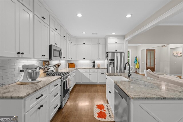 177 Garnett Point Dr, Carrollton, GA 30117 - kitchen with stainless steel appliances, white cabinetry, tasteful backsplash, wood finished floors, and recessed lighting