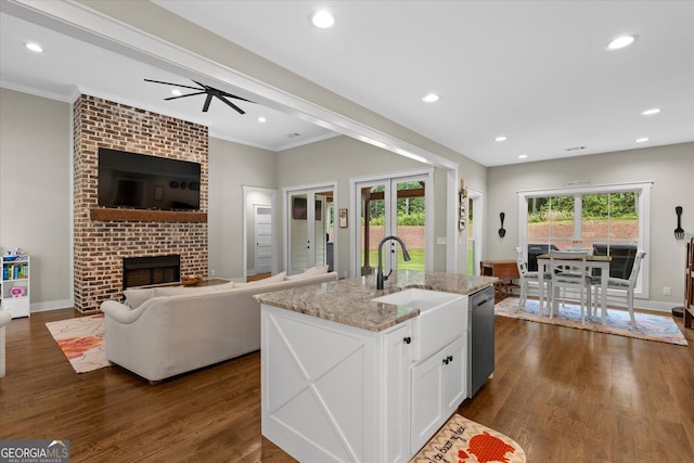 177 Garnett Point Dr, Carrollton, GA 30117 - kitchen featuring light stone countertops, ornamental molding, dark wood-type flooring, dishwasher, and white cabinets