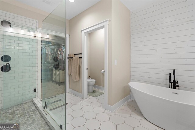 177 Garnett Point Dr, Carrollton, GA 30117 - bathroom featuring a shower stall, a soaking tub, tile patterned flooring, and recessed lighting