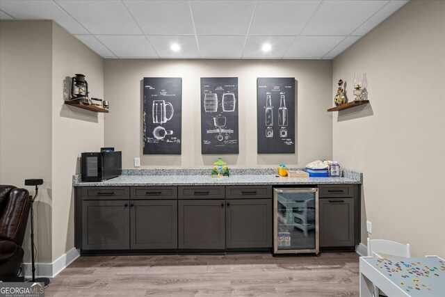 177 Garnett Point Dr, Carrollton, GA 30117 - bar area featuring beverage cooler, a drop ceiling, light wood-style flooring, and recessed lighting