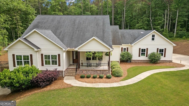 177 Garnett Point Dr, Carrollton, GA 30117 - view of front facade with a front lawn, a shingled roof, and covered porch