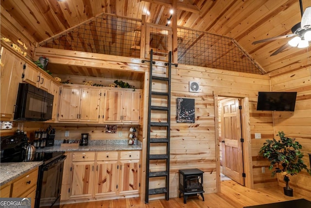 151 Rushmore Ln, Murphy, NC 28906 - kitchen with black appliances, wood walls, a wood stove, wooden ceiling, and light brown cabinets