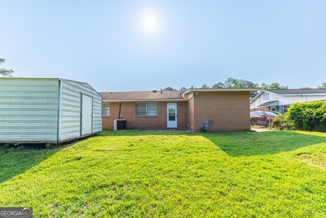 3027 Lansing Ave, Columbus, GA 31907 - rear view of property with a yard, a shed, and brick siding