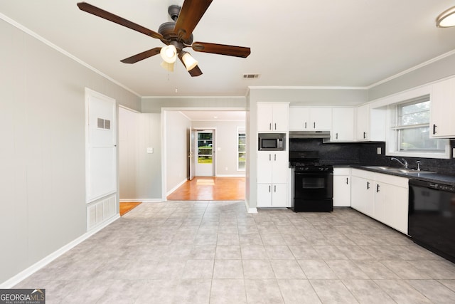 3027 Lansing Ave, Columbus, GA 31907 - kitchen featuring black appliances, under cabinet range hood, ornamental molding, dark countertops, and backsplash