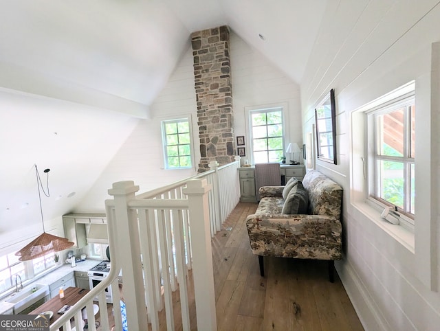 10540 Serenbe Ln, Chattahoochee Hills, GA 30268 - sitting room with light wood finished floors, vaulted ceiling, and healthy amount of natural light