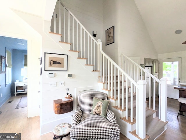 10540 Serenbe Ln, Chattahoochee Hills, GA 30268 - stairway with wood finished floors and high vaulted ceiling