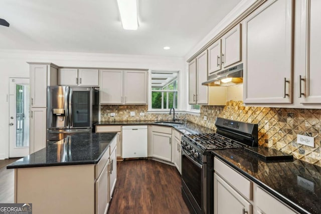 2539 Larson Creek Cv, Duluth, GA 30097 - kitchen with gas stove, stainless steel refrigerator with ice dispenser, dishwasher, under cabinet range hood, and dark wood-style floors