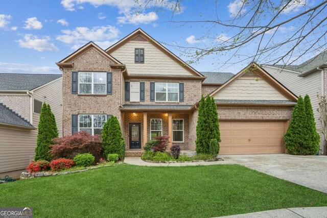 2539 Larson Creek Cv, Duluth, GA 30097 - craftsman-style house with brick siding, concrete driveway, an attached garage, and a front lawn